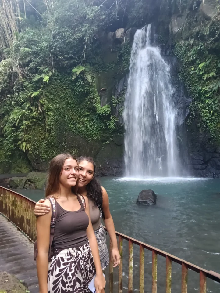 A traveller standing beside a waterfall
